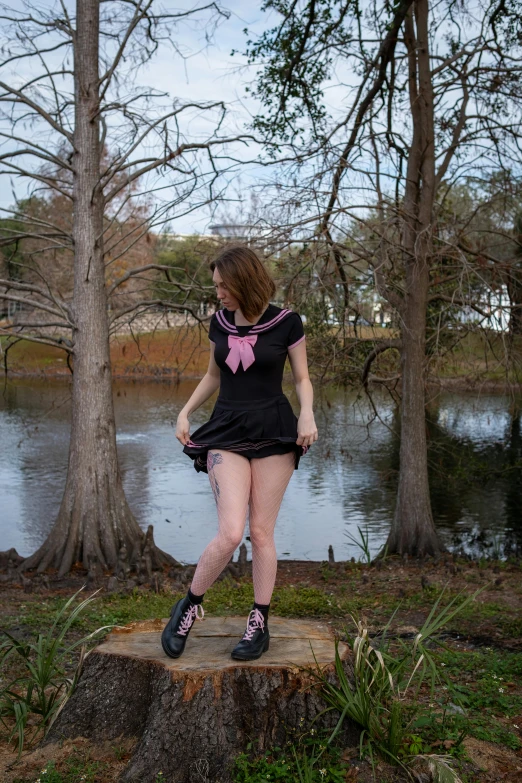 a person wearing short pants and socks standing by a lake