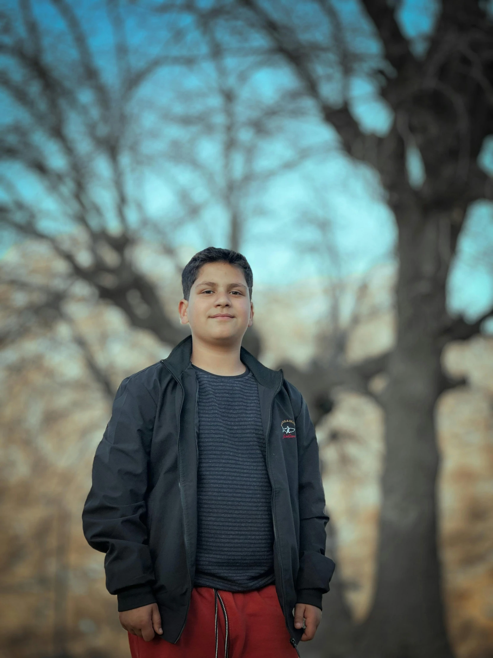 a guy standing in front of a tree