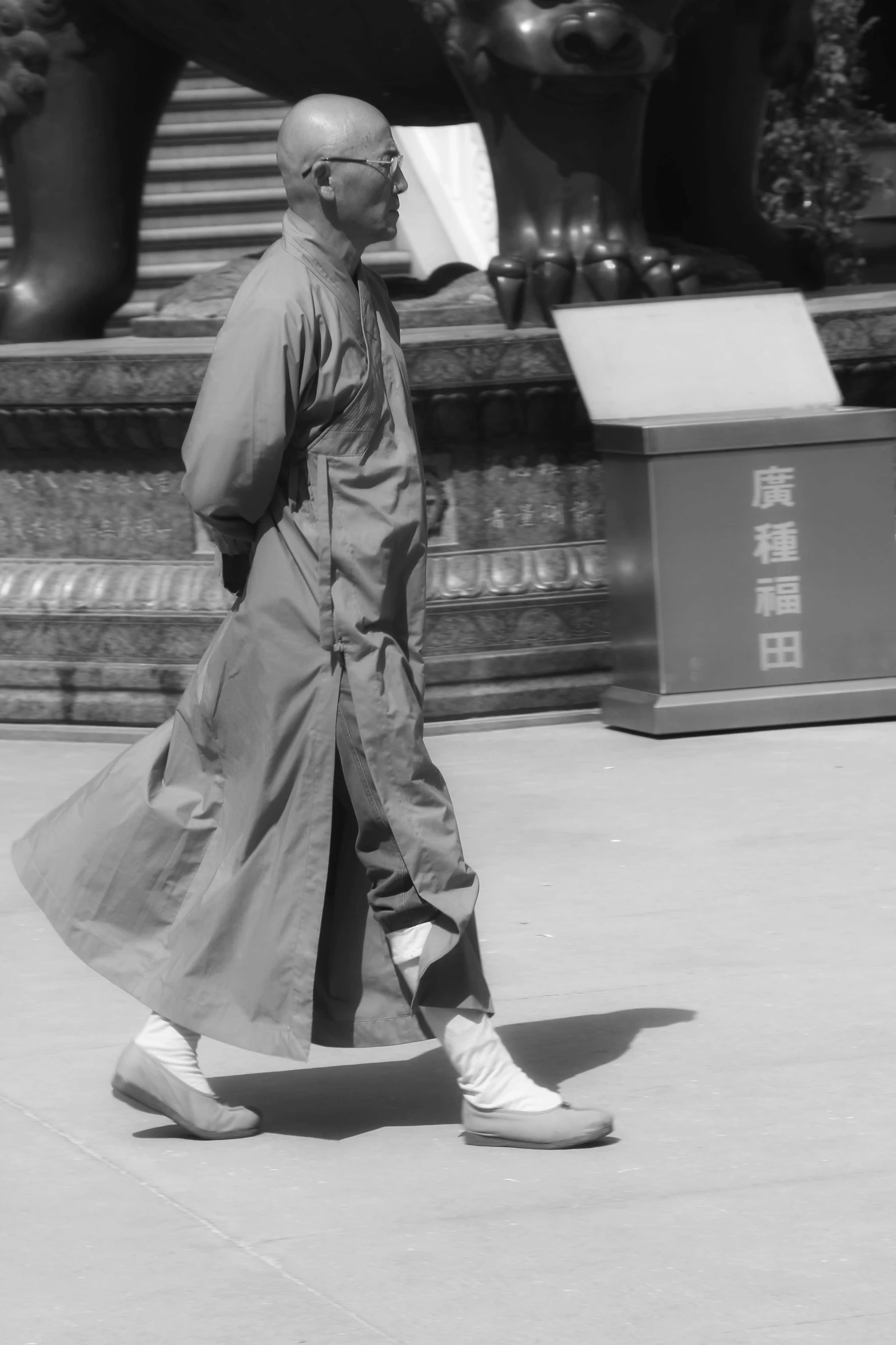 a man walking down the street with a bag on his shoulder