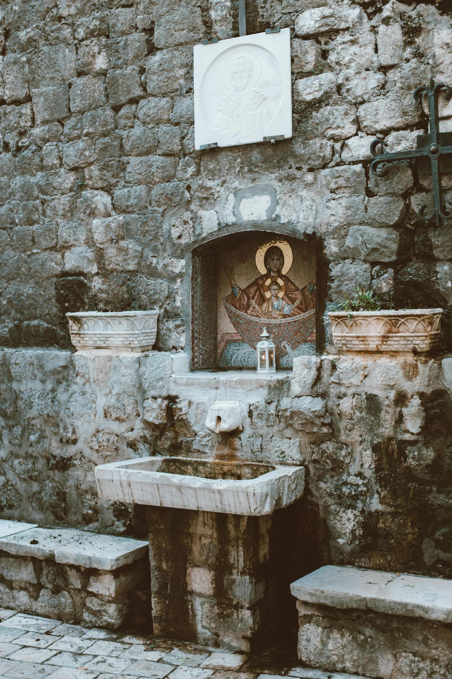 a small stone shrine with a statue on top