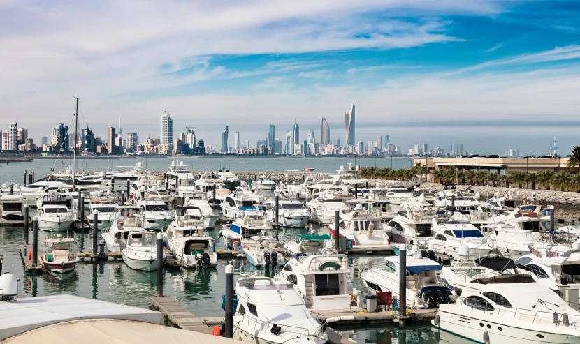 many boats are parked along a harbor and in the city