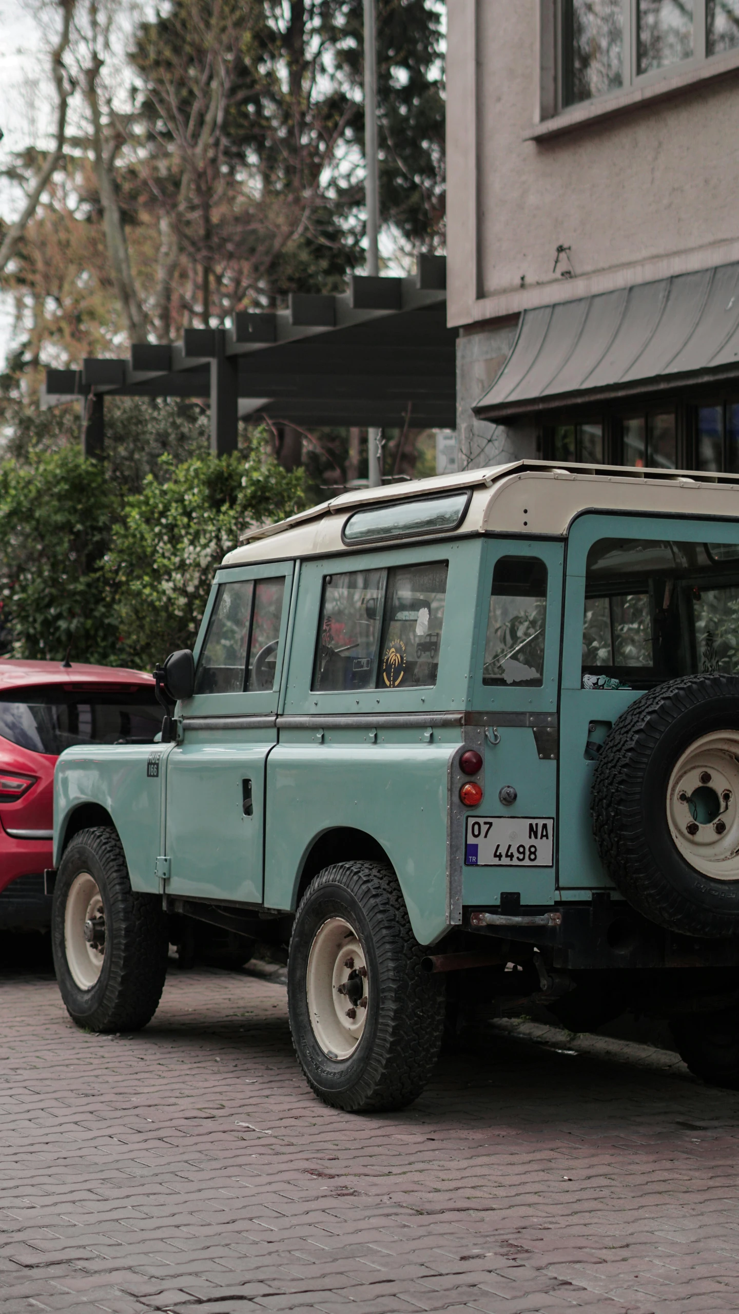 a large green suv is driving on the road