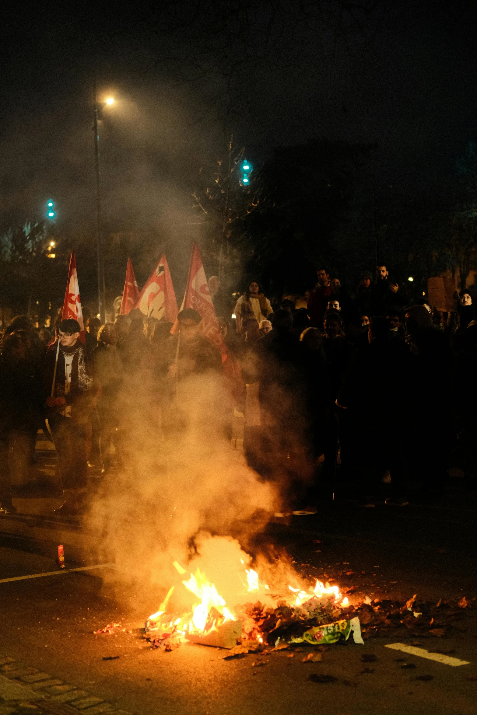 a large pile of fire with many flags surrounding it