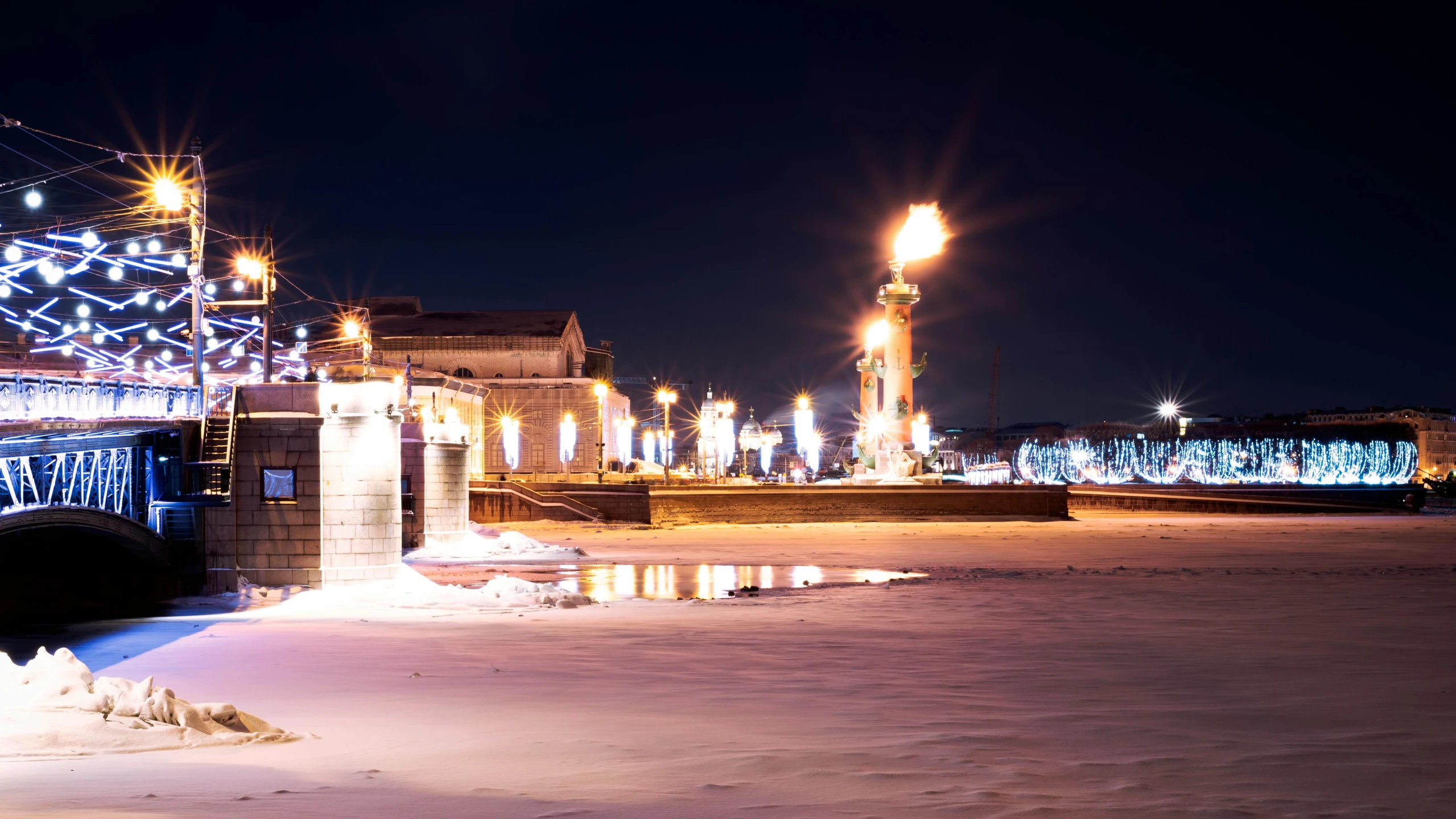 city street in the winter with a bridge on it