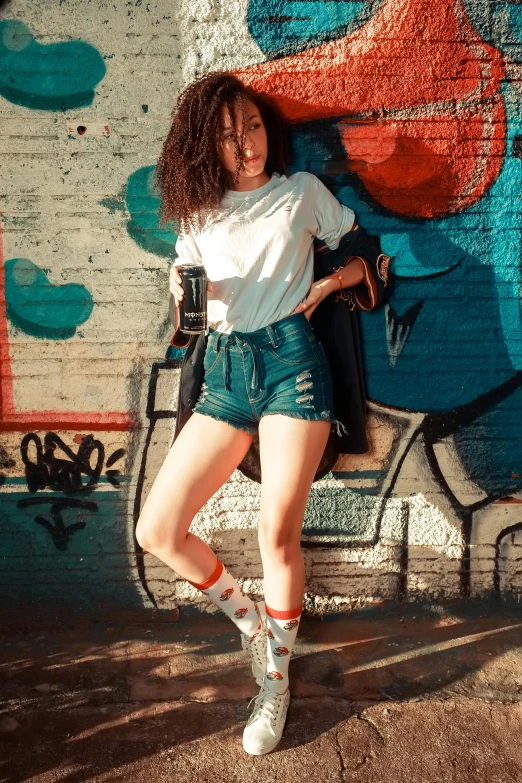 a woman posing for a po by a wall