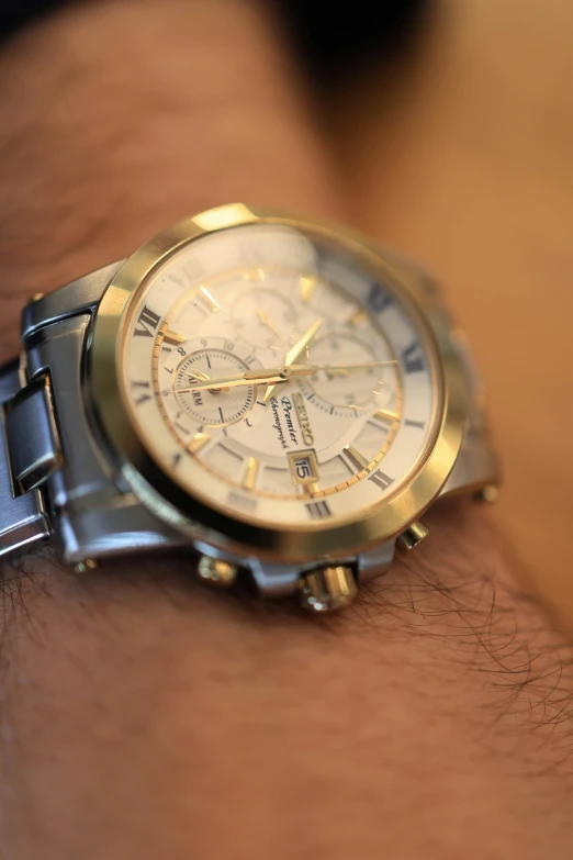 a closeup of a wrist watch on someone's arm