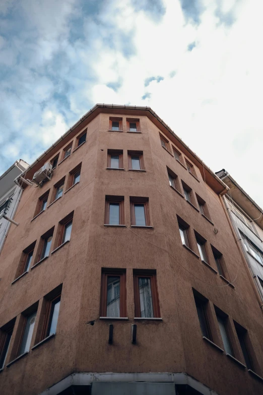 looking up at an old building with some windows