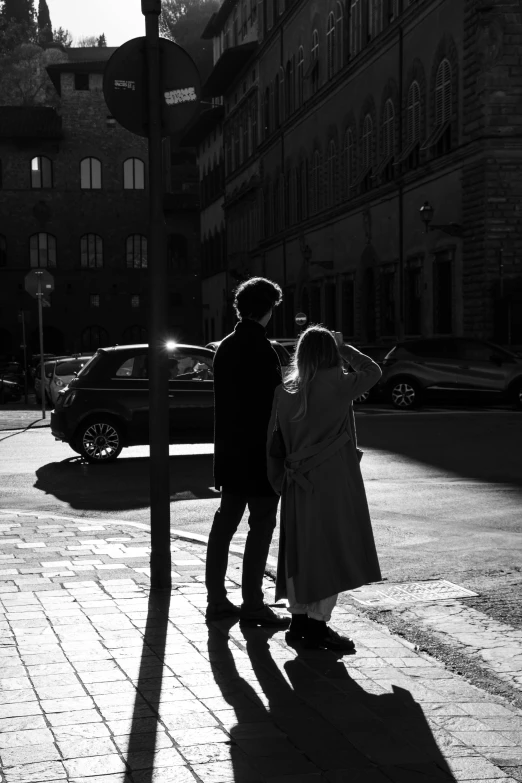 a couple of people on a road with shadows