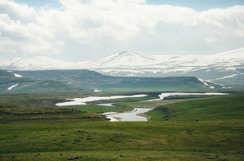 the mountains are covered in snow and clouds