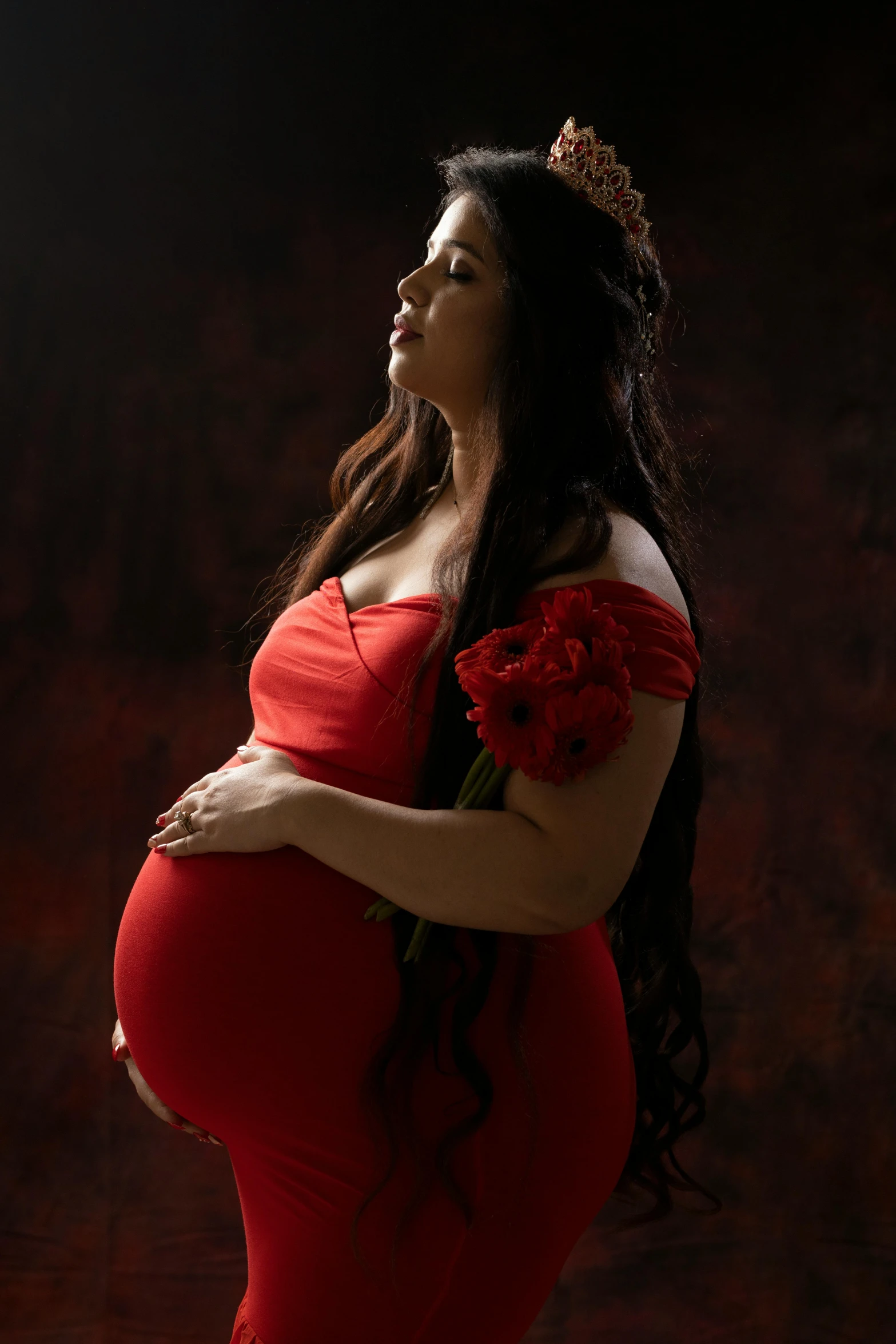 pregnant woman with a rose crown on her head