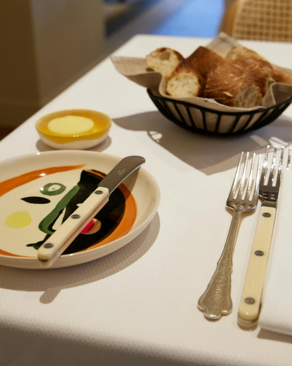 two bowls of bread, er and fork are shown on a table