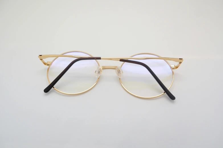 a pair of glasses on top of a white surface