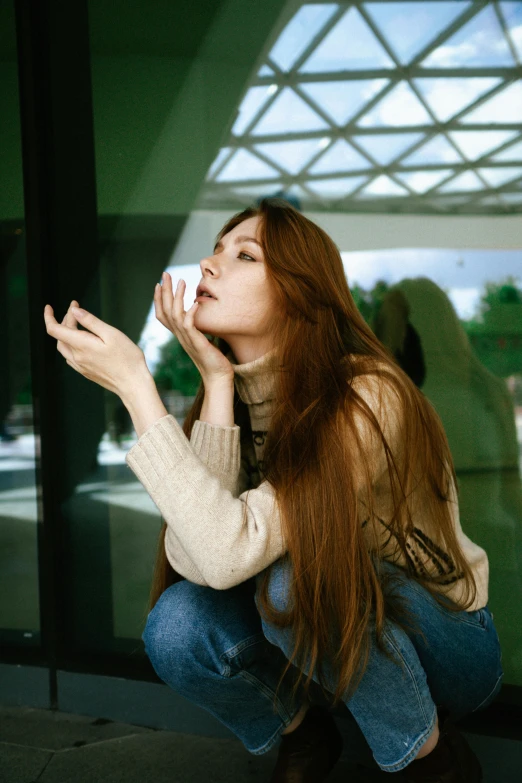 a woman that is kneeling down looking up