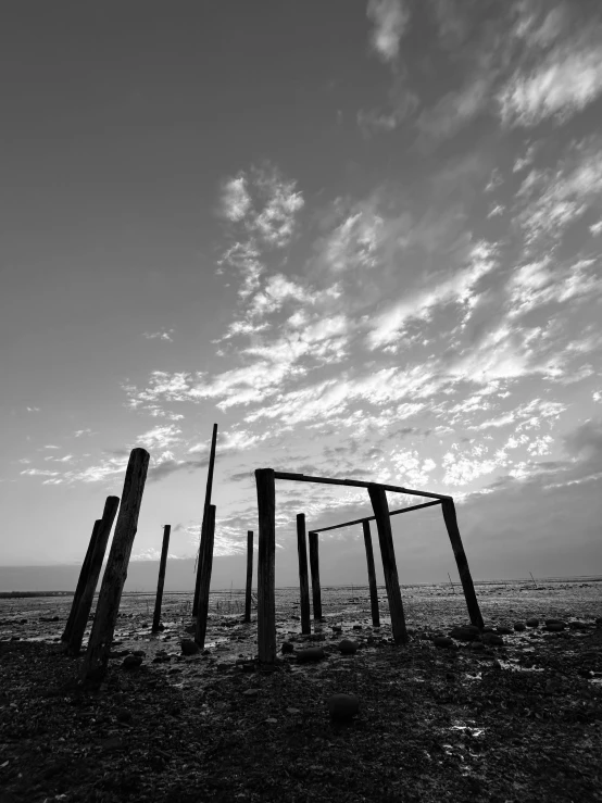 two wooden structures with pillars on the beach