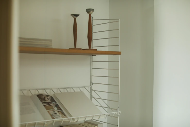 the interior of an apartment has white shelving and utensils