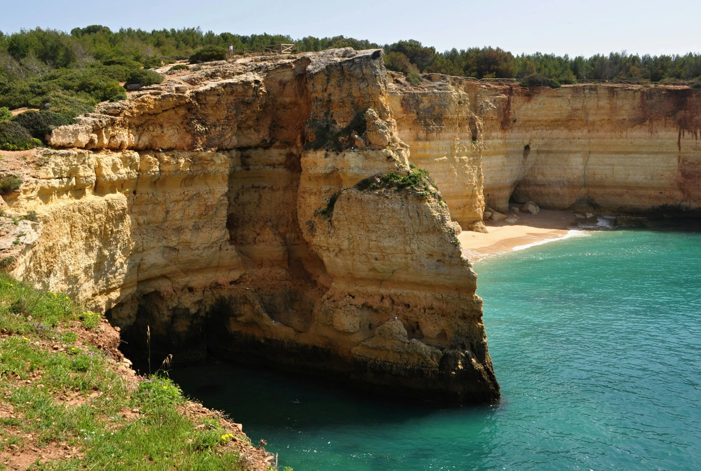 the view of the blue waters from the cliffs at a beach