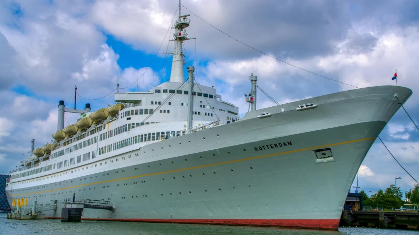 a cruise ship sits at the dock as the sky looks overcast