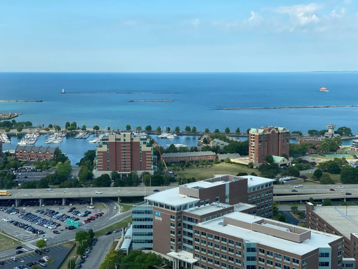 a parking lot with cars parked on it and a body of water