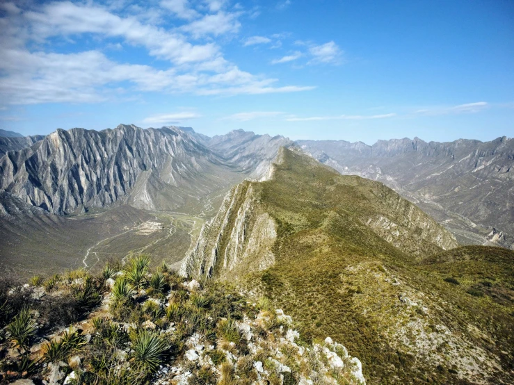 a man is flying a kite on a mountain