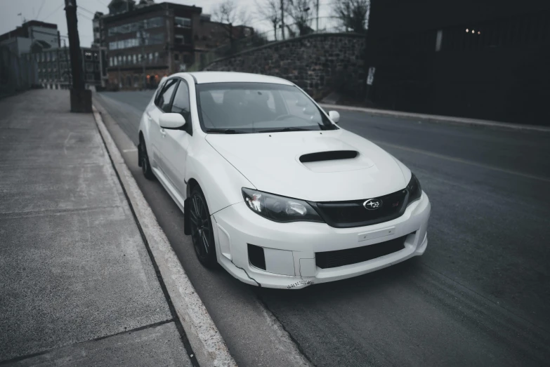 a white car parked on the side of the street