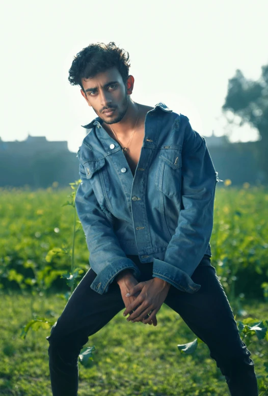 a man leaning up in a field looking around