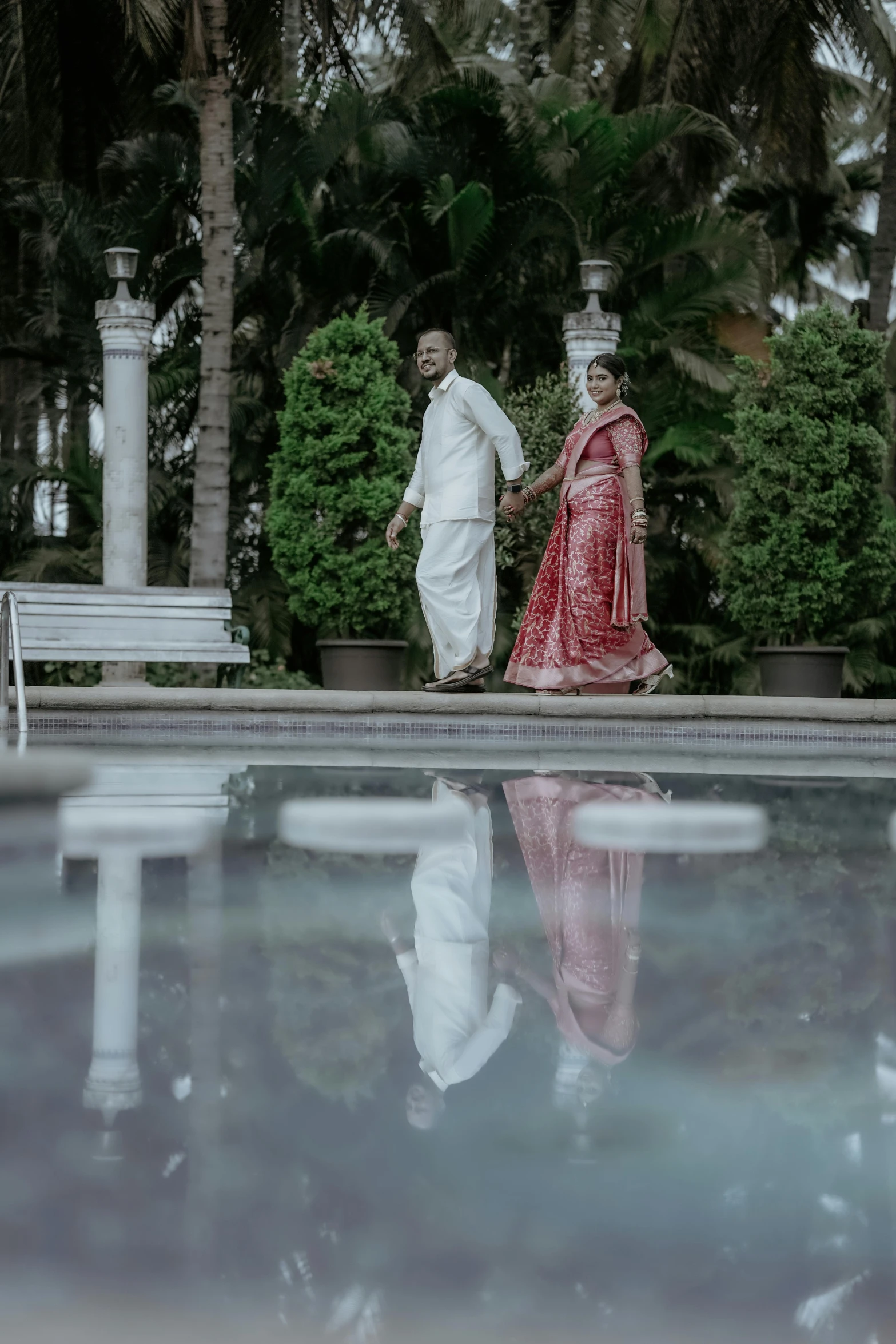 a couple dressed in traditional attire walking away from each other