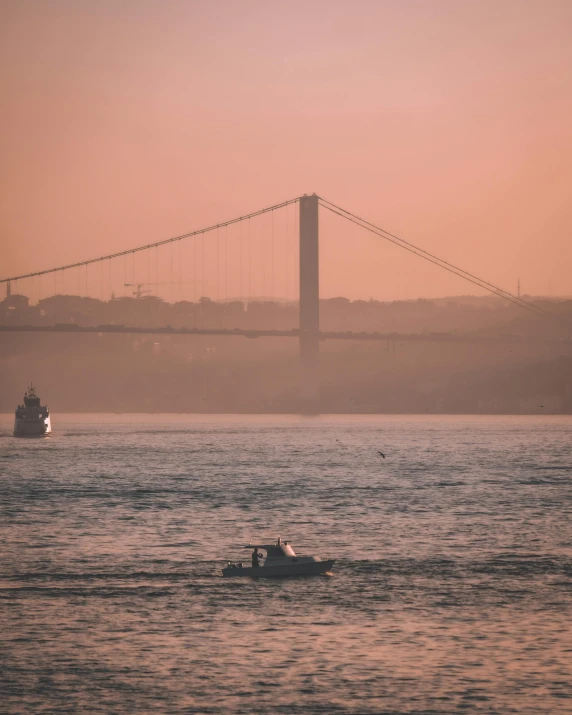 a boat in the water and a bridge in the background