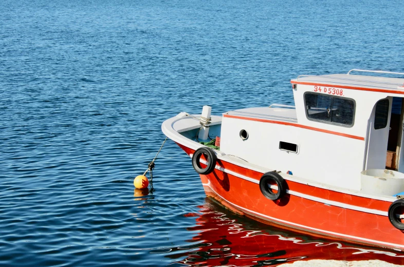 a boat tied to a small dock on the water