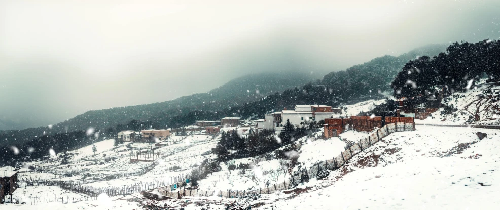 several buildings stand on the top of a mountain