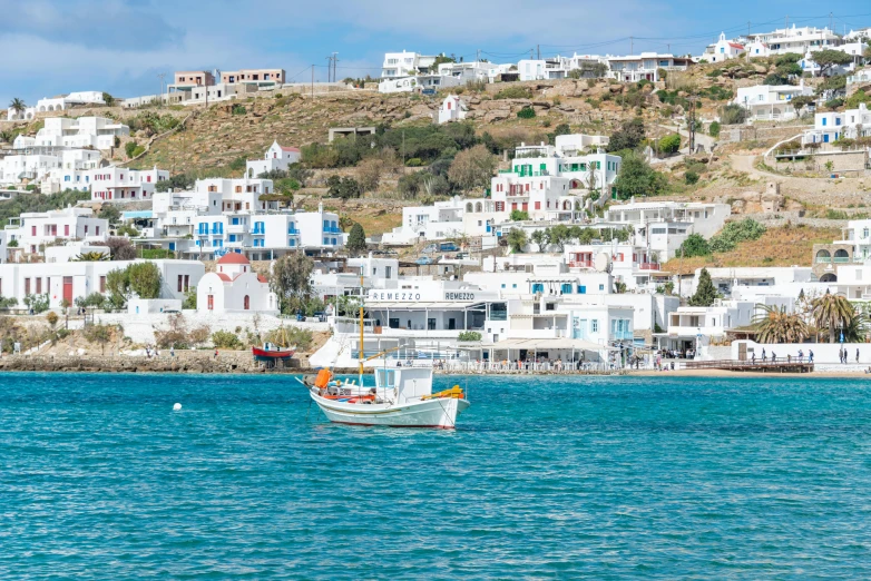 a white boat floating on top of the ocean