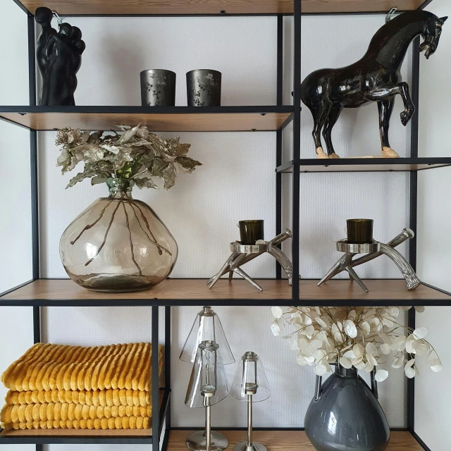 several shelves with vases of flowers and animals, candles, vases and gold figurines