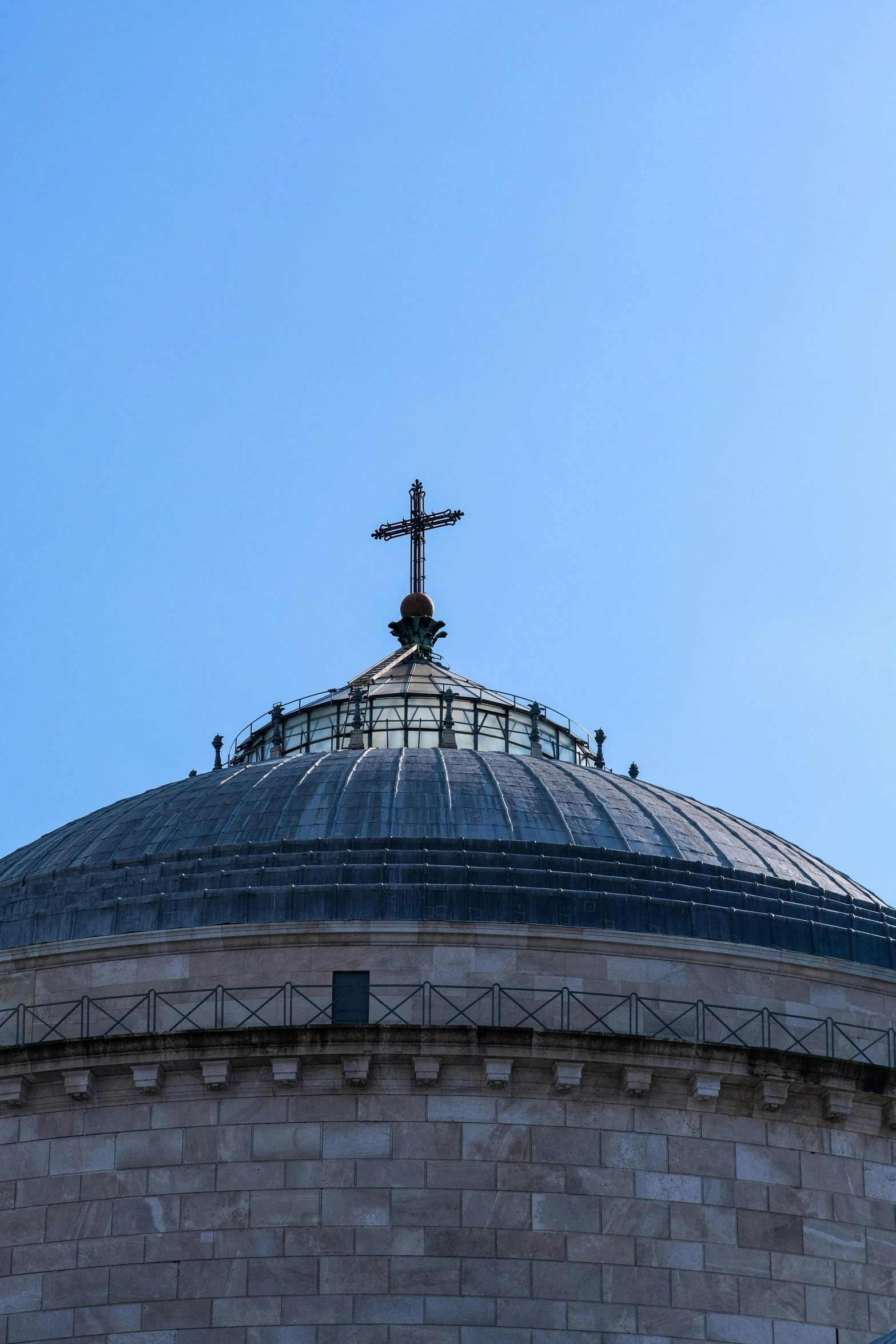 the cross is on top of the building against the blue sky