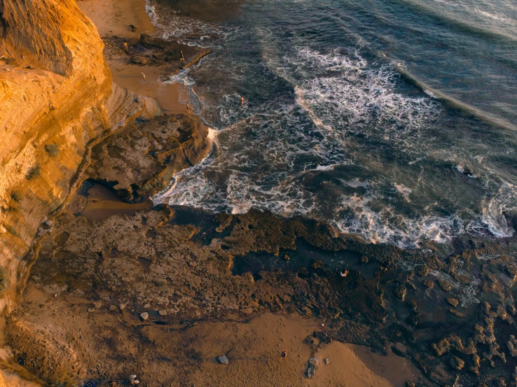 this is an aerial view of some water and beach