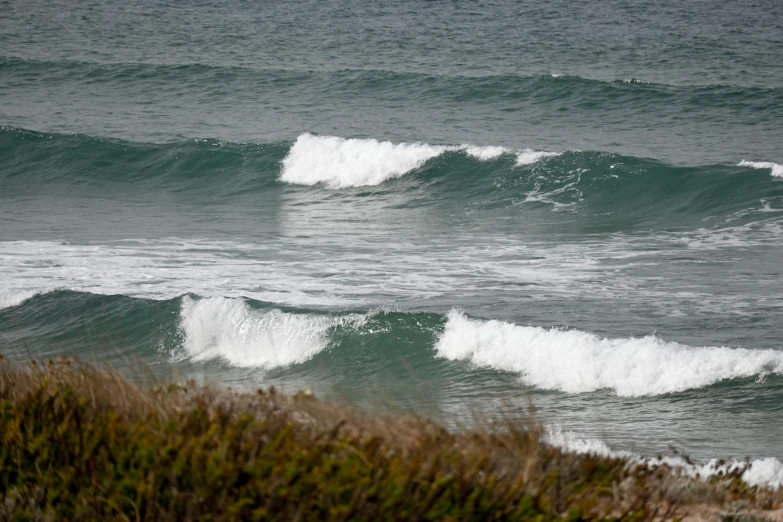 a couple of small white waves in the ocean