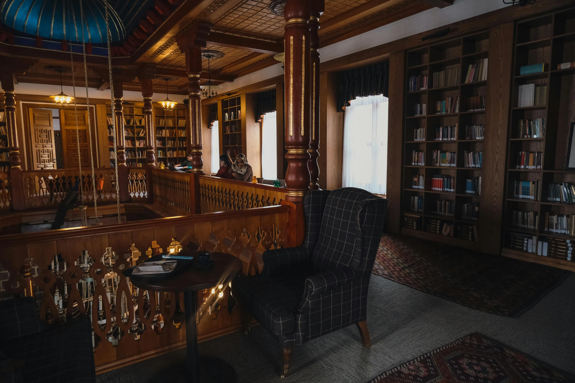 a large liry with tables, bookshelves and chairs