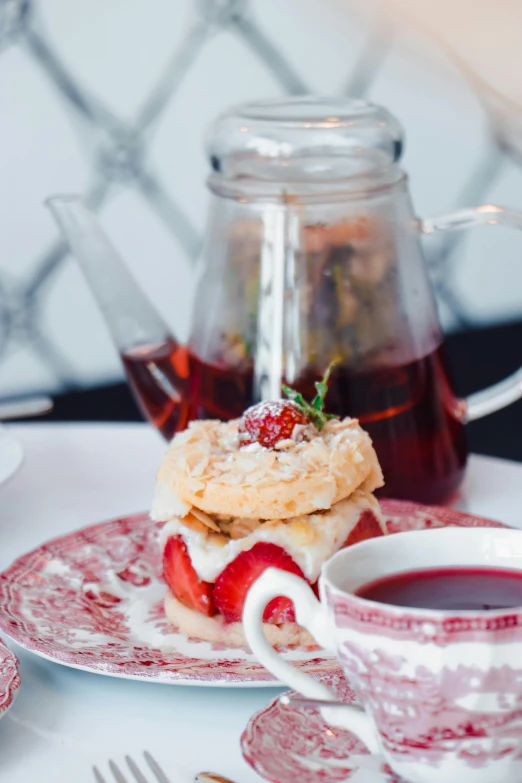 a tea party with strawberry shortcakes and a tea pot