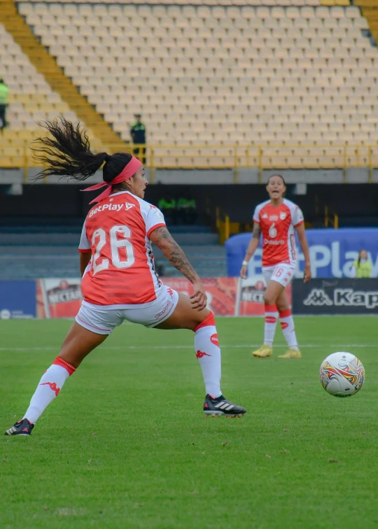 a soccer player running with the ball on the field