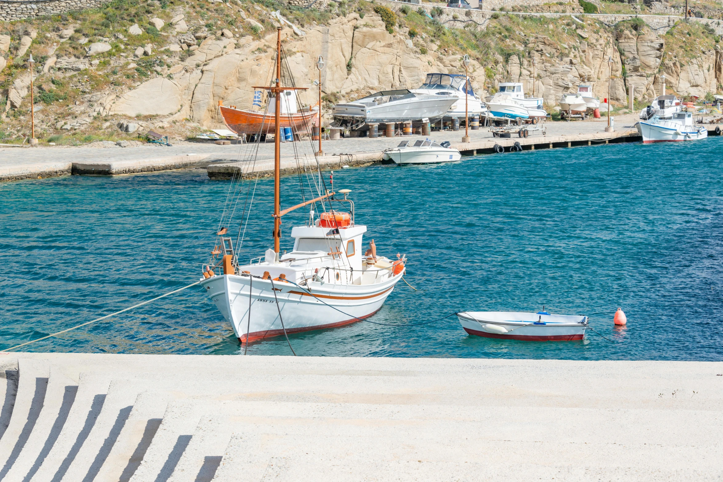 some boats sitting on the water near the pier