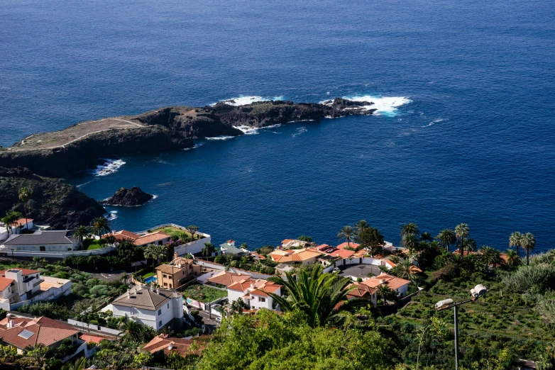 the ocean and surrounding houses overlook a small island