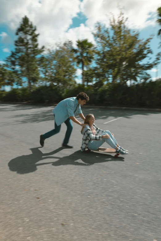 a woman helping another girl with skateboard in a parking lot