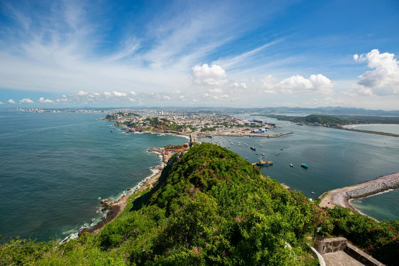 view of a hill with water and an island in the background