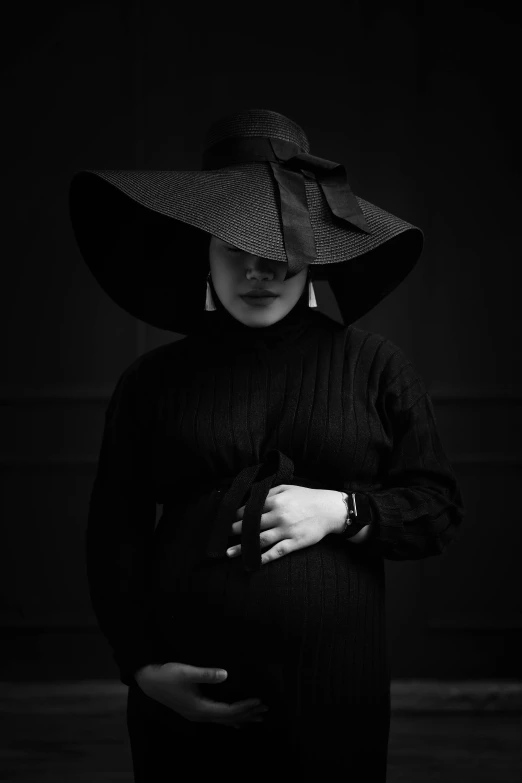 a woman wearing a large hat posing for the camera