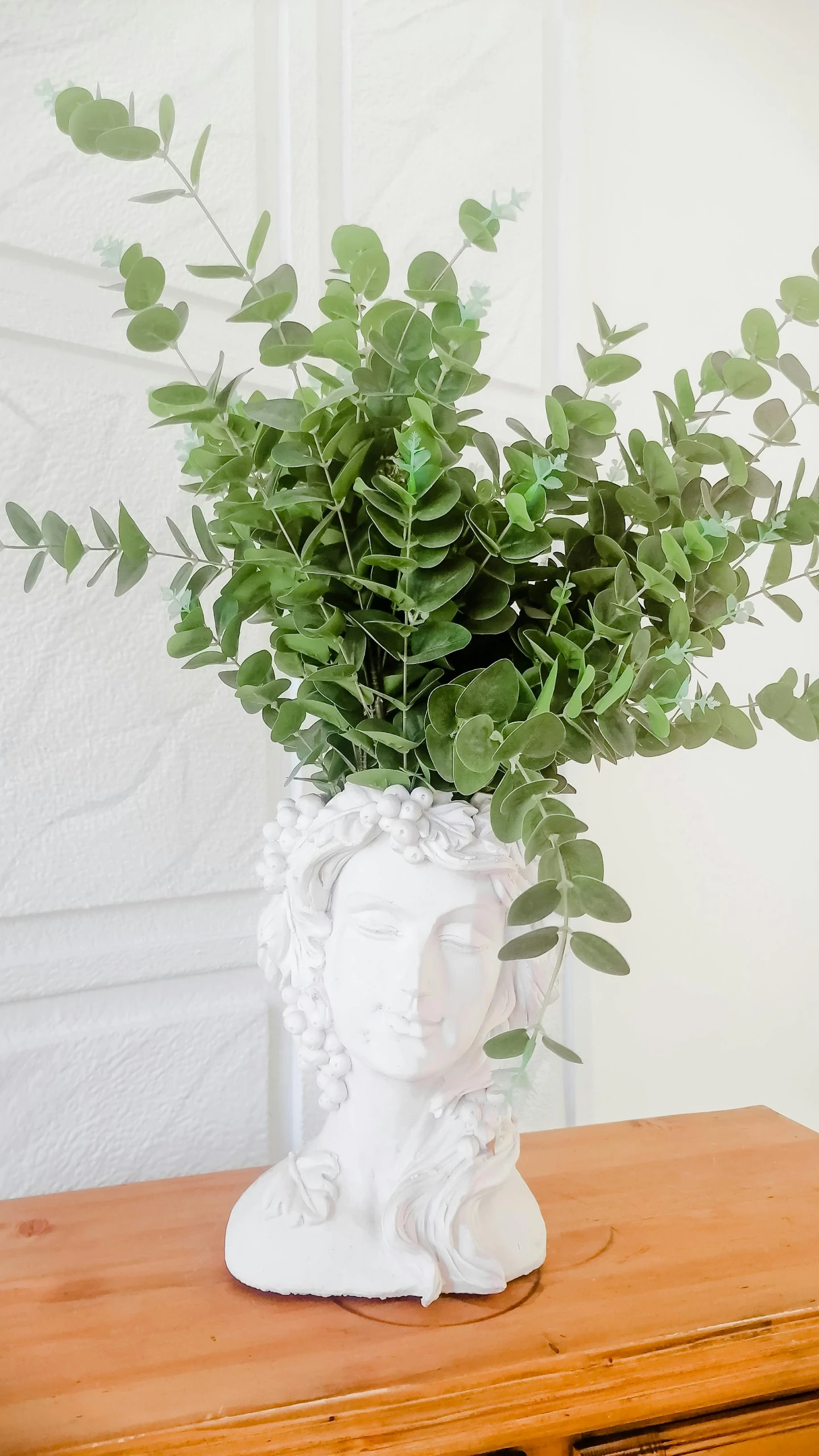 a plant in a decorative vase on a table