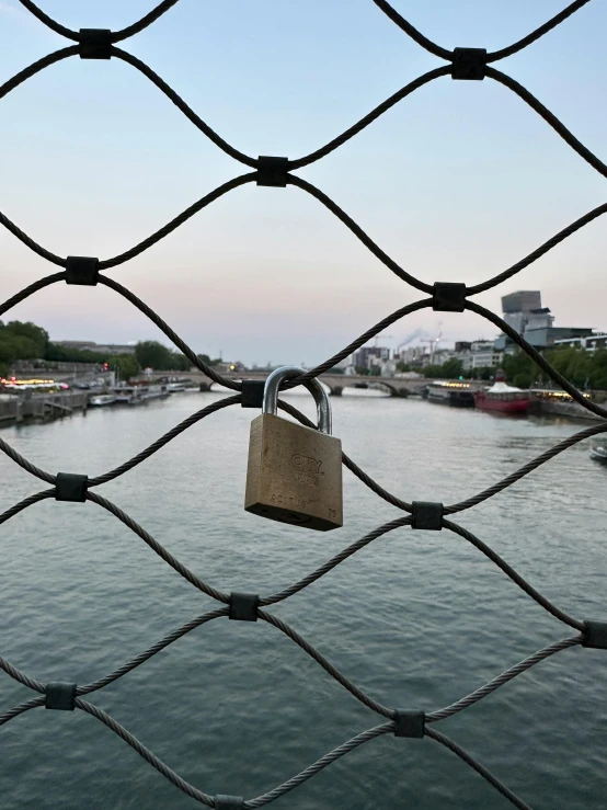 a padlock on the fence of a canal