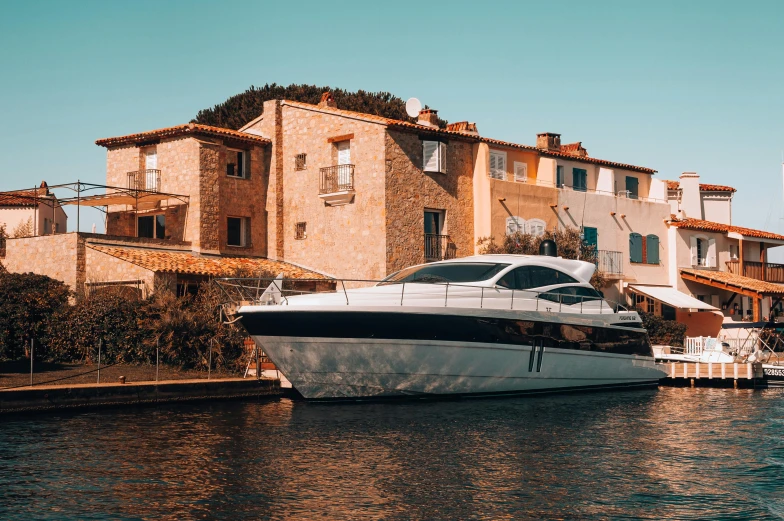 an enormous yacht is anchored in front of a row of old town homes