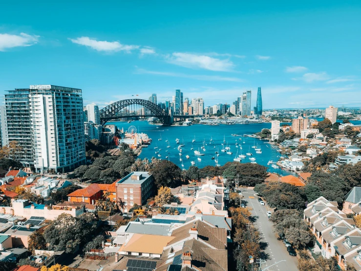 a view from the top of a tower with a city skyline and boats in water below