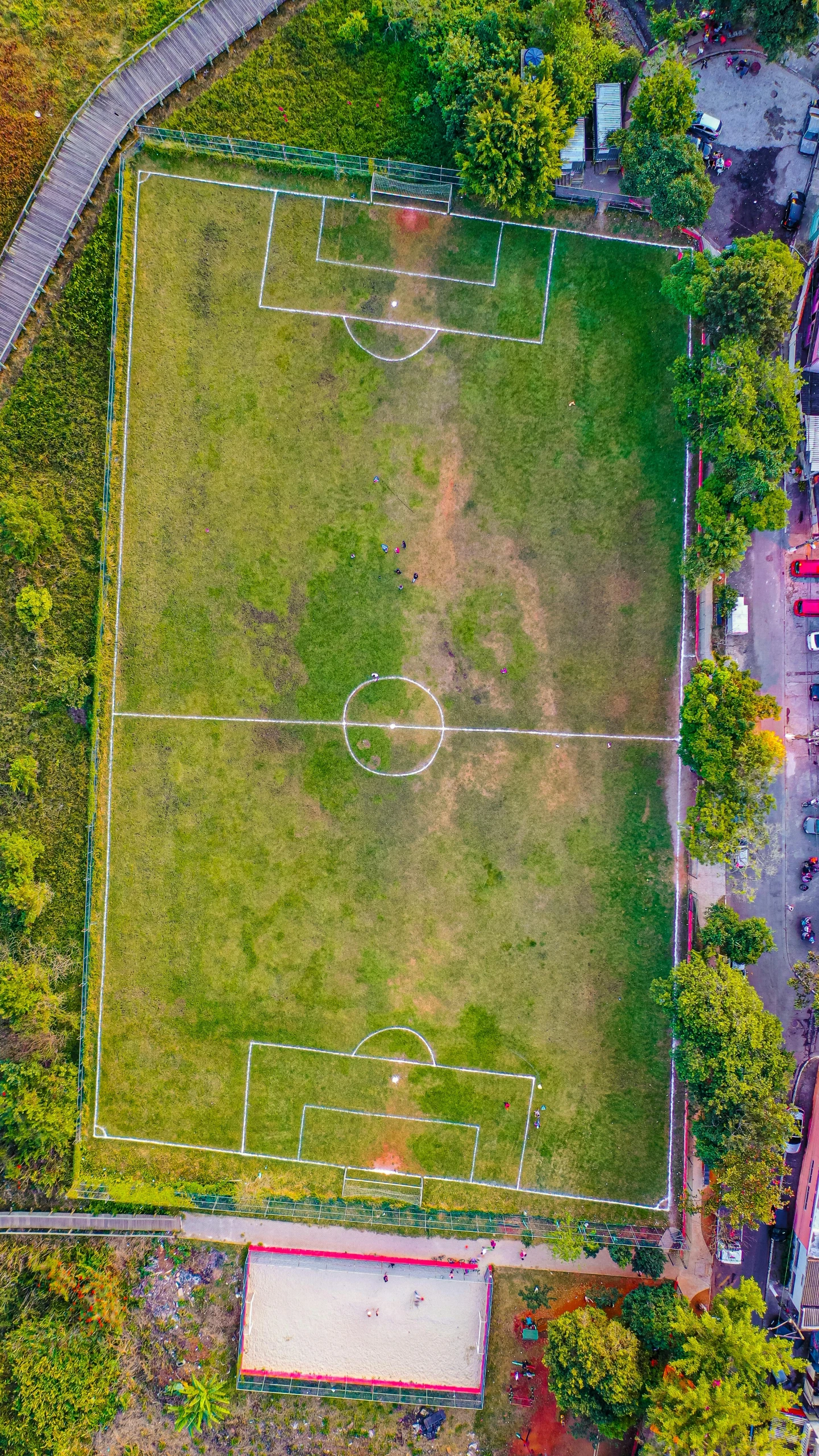 an aerial po of an athletic field with a parking lot