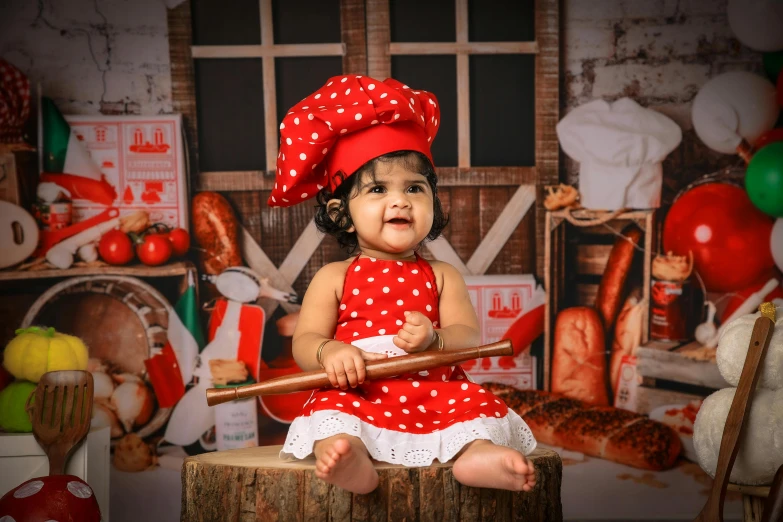 a little girl sitting on top of a wooden barrel