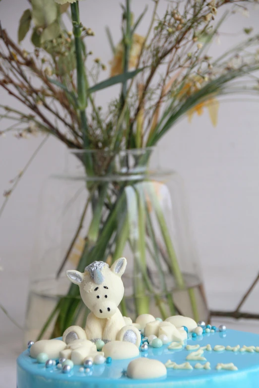 a small cake sitting in a vase with flowers in it