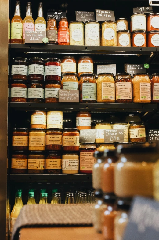 a rack full of honey jars and jars of jam